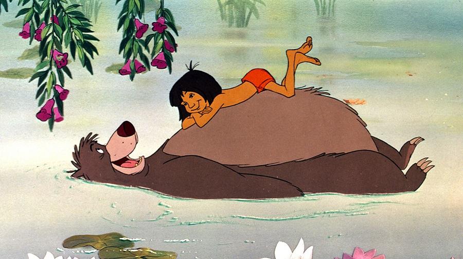 image of Balloo bear floating on his back with Mowgli lying on his stomach