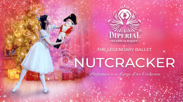 young girl in white dress holding a nutcracker