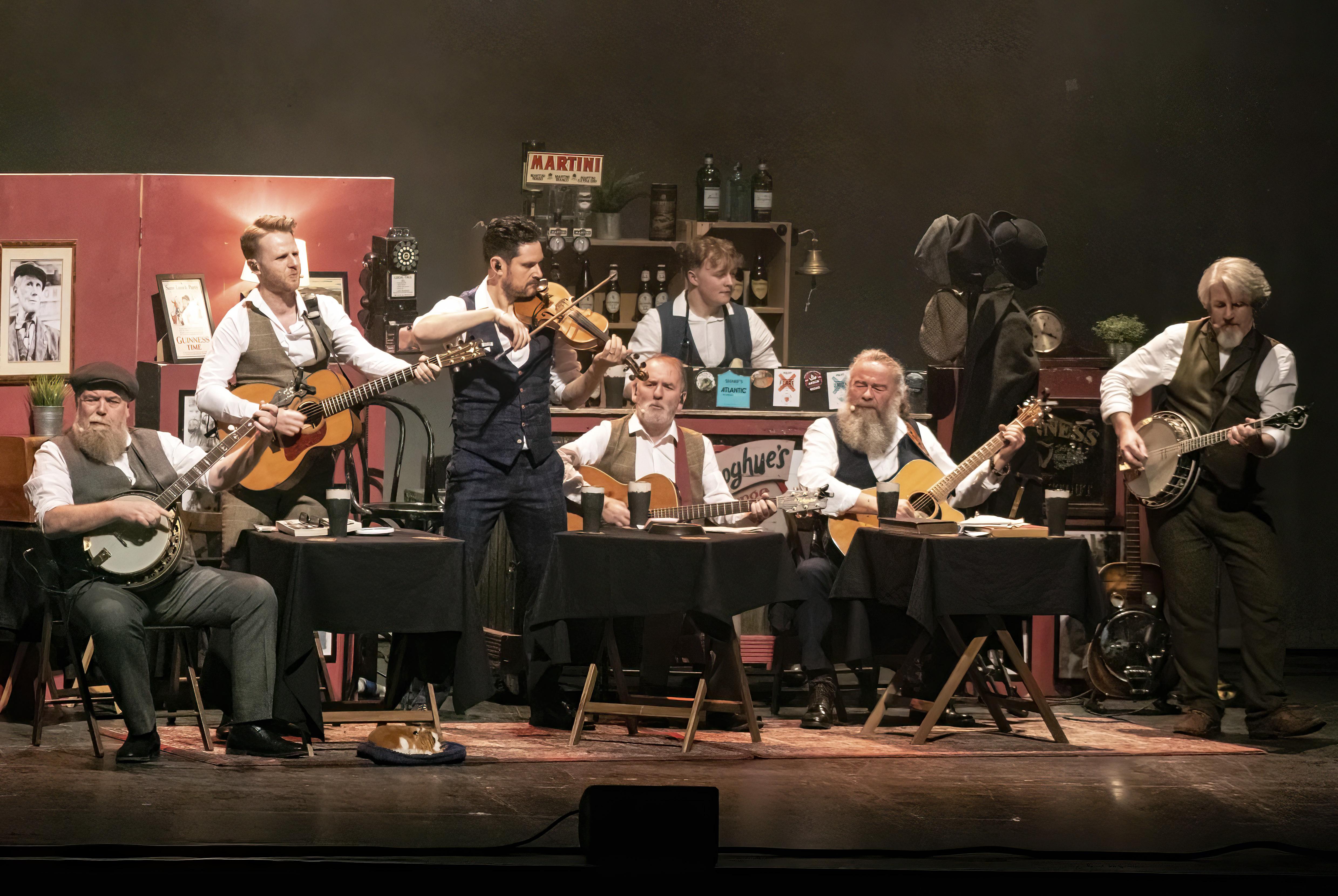 Group of men in waistcoats playing musical instruments