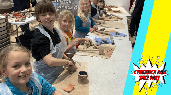 a group of children making clay cups 