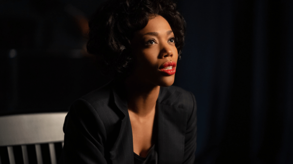 image of naomi ackie as whitney sat on chair looking forward